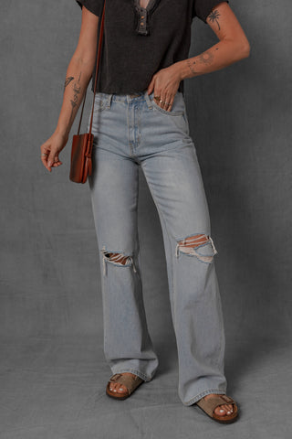 women modeling light wash denim jeans with distressed knees